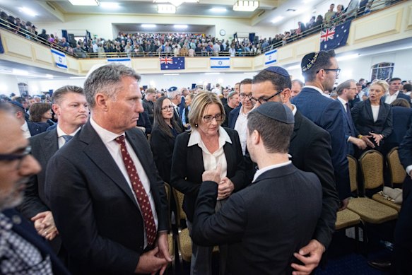 Premier Jacinta Allan is spoken to by a Jewish community member at the Caulfield Shule while Deputy Prime Minister Richard Marles and local MP Josh Burns look on.