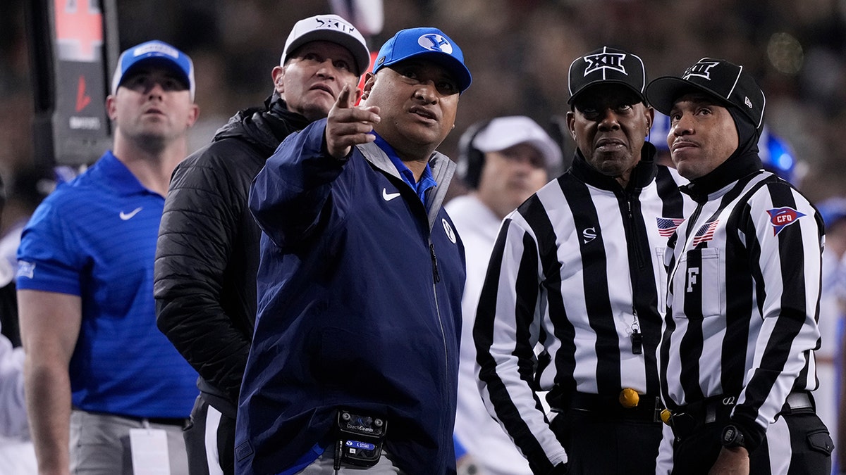 Kalani Sitake talks to officials