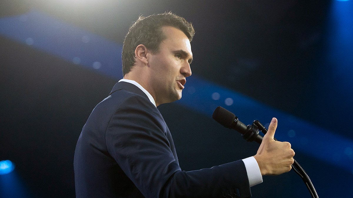 Charlie Kirk speaking into a microphone