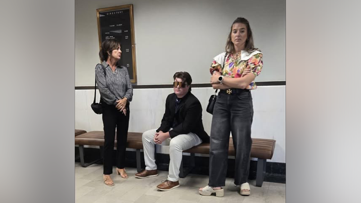 Jesse Butler sits down with sister and mother near by