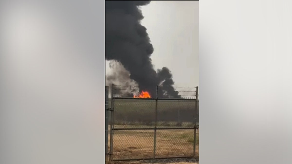 Fire and black smoke at the site of a plane crash