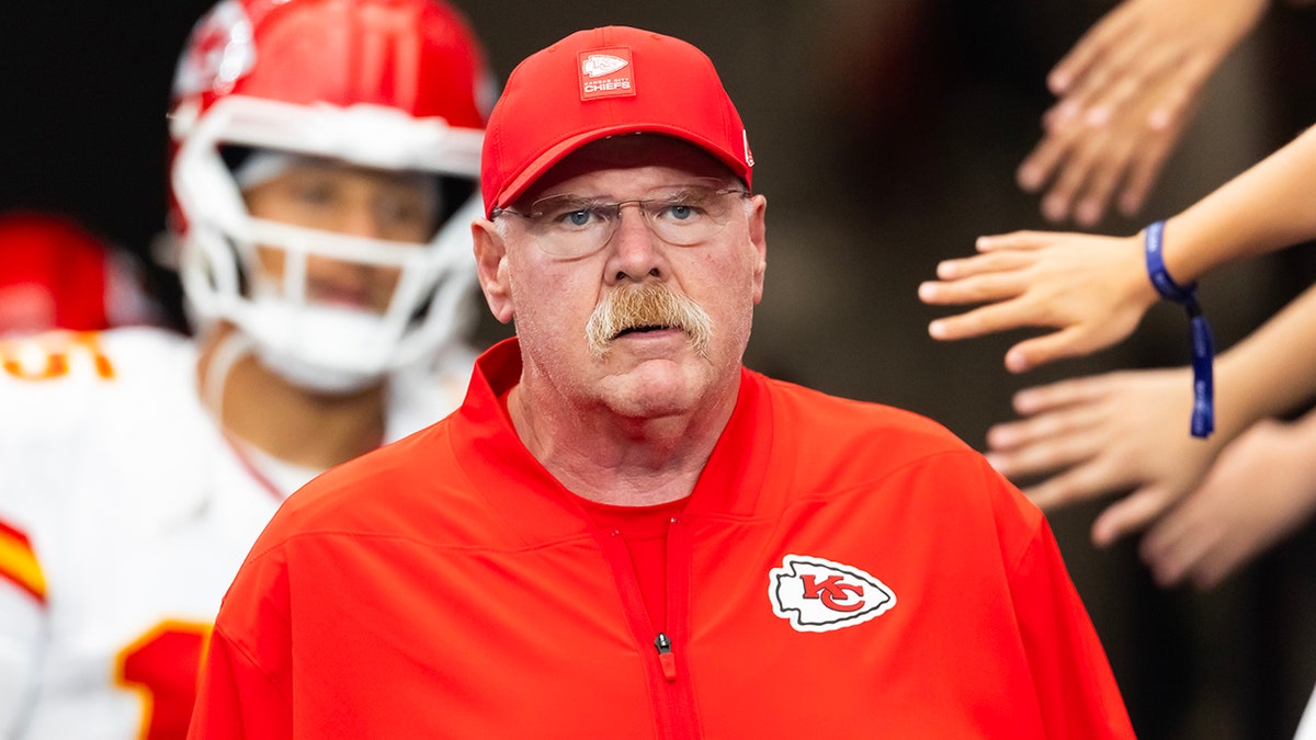 Andy Reid walks onto the field