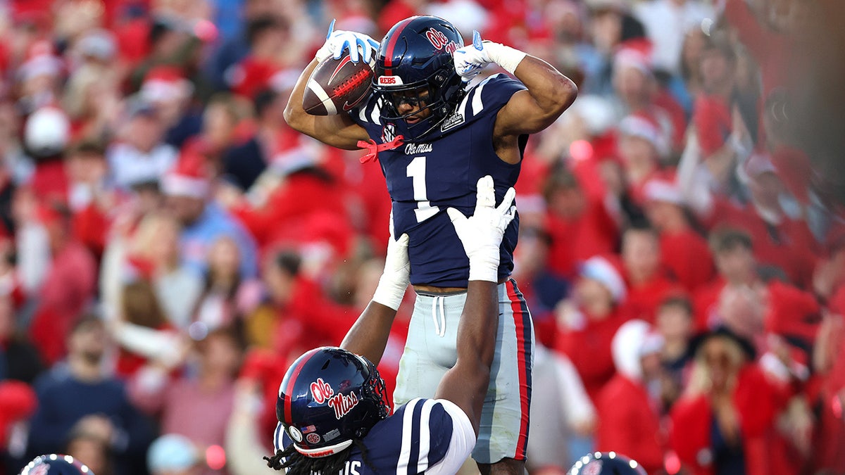 Ole Miss football players celebrate