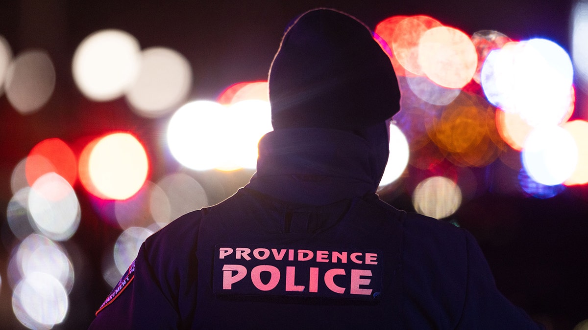 Person with "PROVIDENCE POLICE" on the back of their outfit