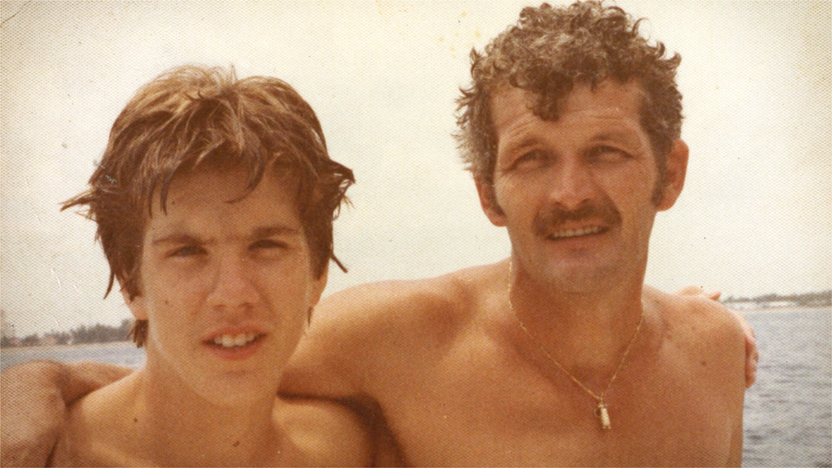 Richard Darress and his son, Rich, embracing each other at the beach.