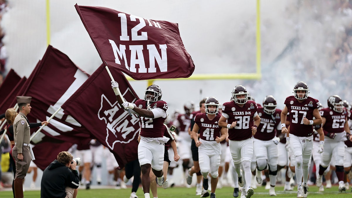Texas A&M Aggies runs from the tunnel 