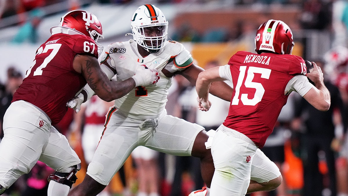 Fernando Mendoza runs from the defense