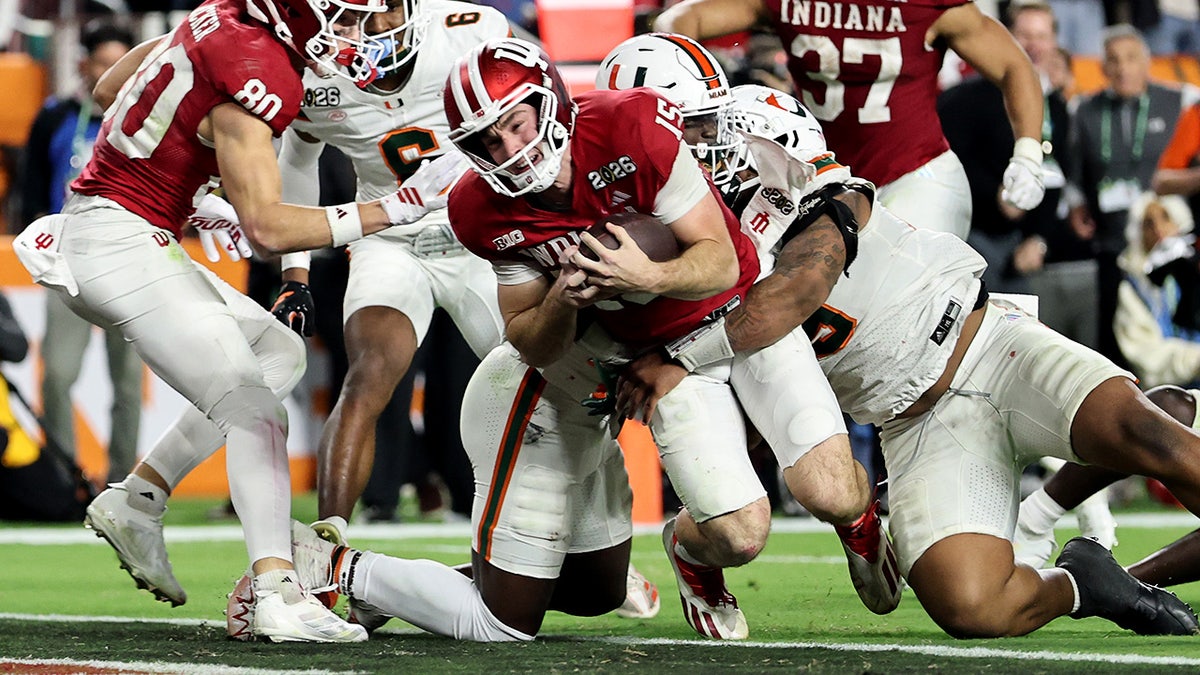 Fernando Mendoza dives into the end zone