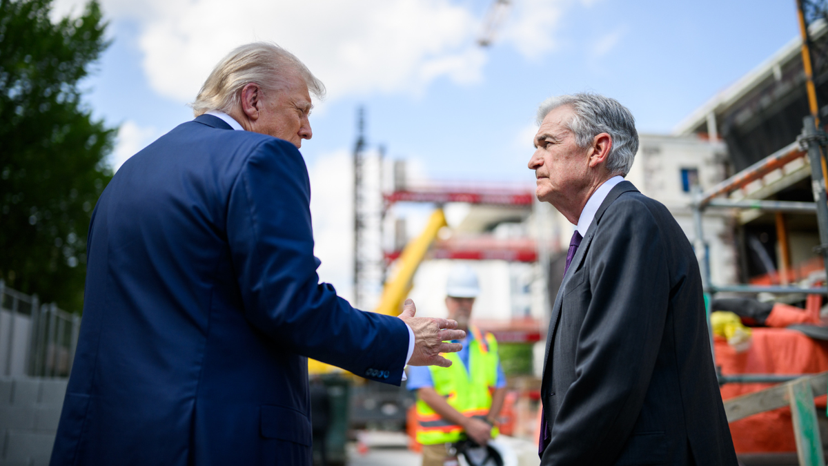 President Donald Trump speaks to Fed Chair Jerome Powell at Federal Reserve construction site