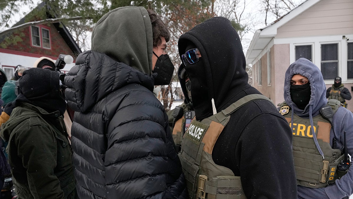 Minnesota protester and federal law enforcement agent confront each other