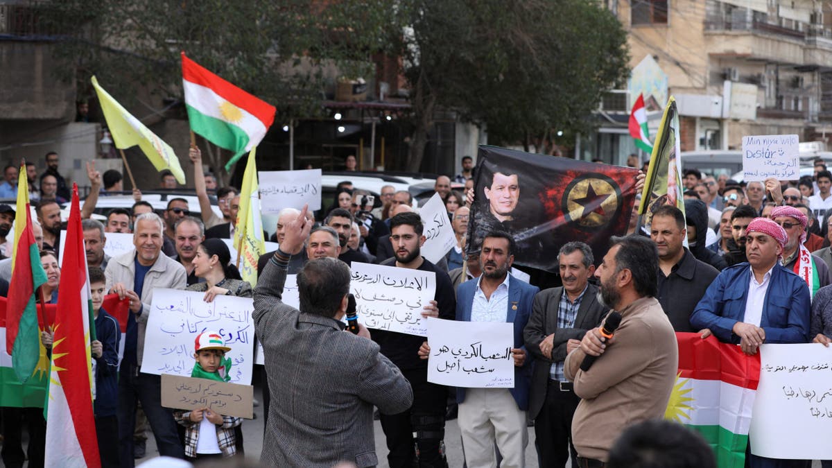 People holding Kurdish flags demonstrate against the constitutional declaration that was drafted by experts and signed by Syria's interim President Ahmed al-Sharaa on Thursday, in Qamishli, Syria March 14, 2025.