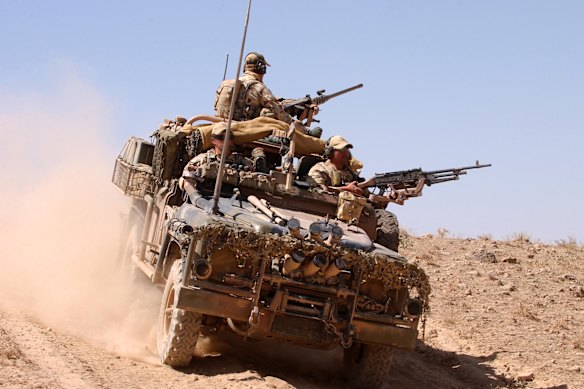 An Australian surveillance reconnaissance vehicle patrols an operating base in Afghanistan in 2005.
