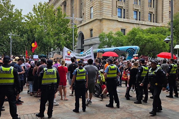 Police moving protesters on after an object was thrown into the crowd at Perth’s Invasion Day rally. 