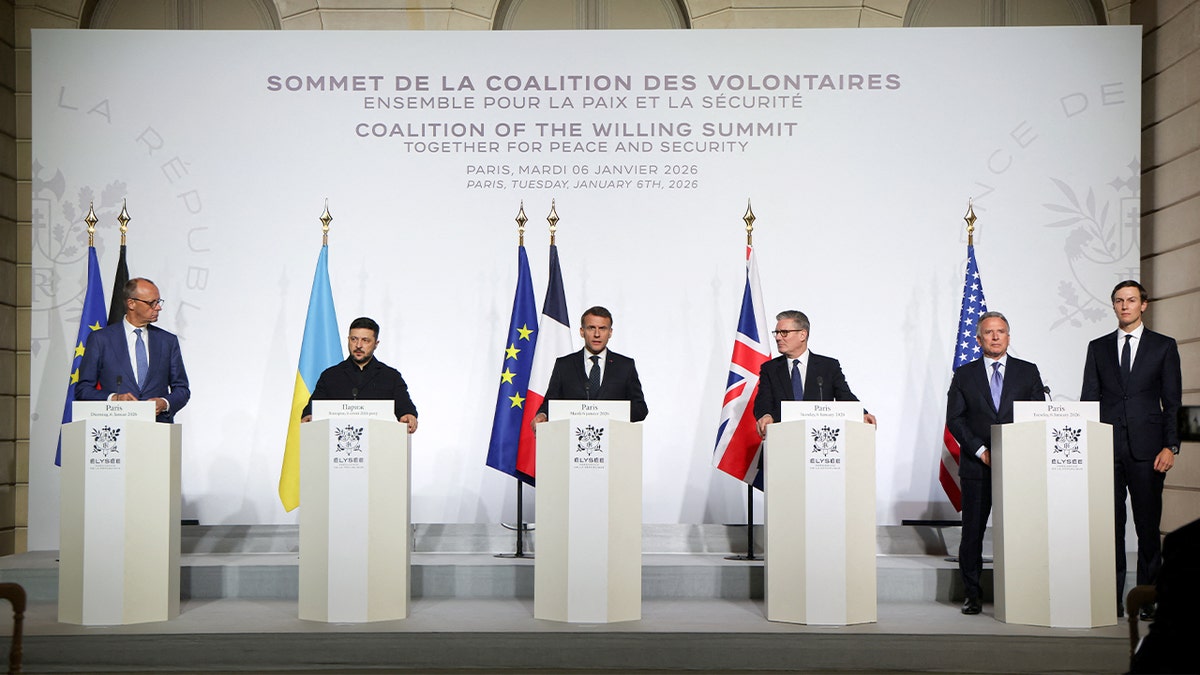 World leaders stand together at a podium during a joint announcement at a diplomatic summit.