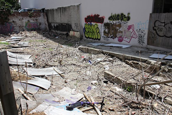 The site at 440 Upper Edward Street in Spring Hill on Thursday afternoon, with a dumped Neuron e-scooter in the foreground. 