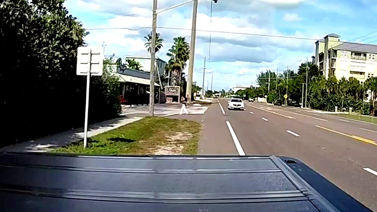 John Brittingham carrying girls out of the road