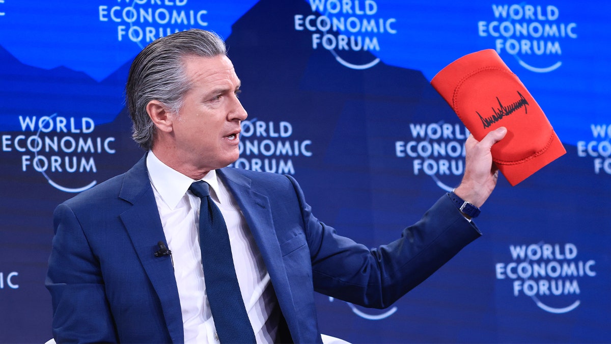 California Gov. Gavin Newsom displays kneepads during a public appearance at an international forum.