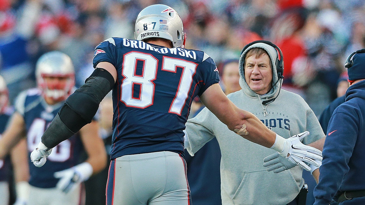 Gronk high fiving Belichick