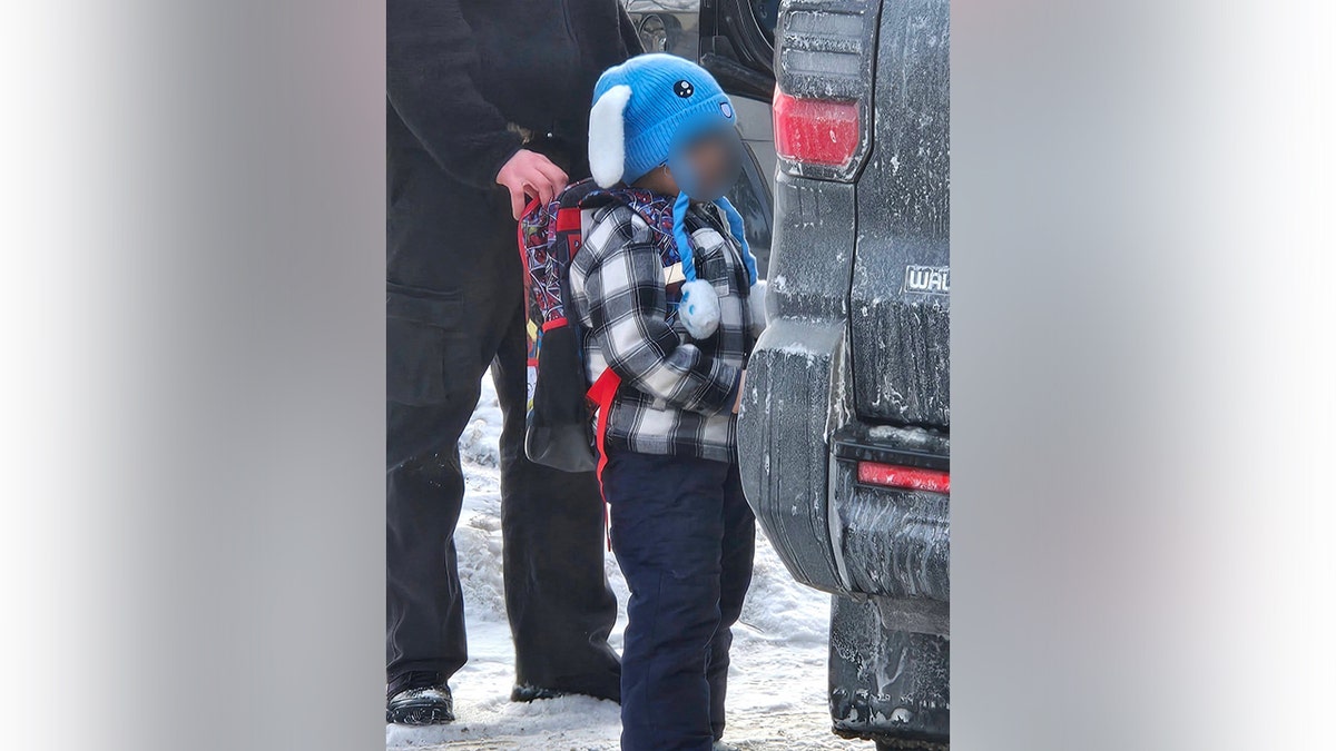 Five-year-old Liam Conejo Ramos is led into a vehicle