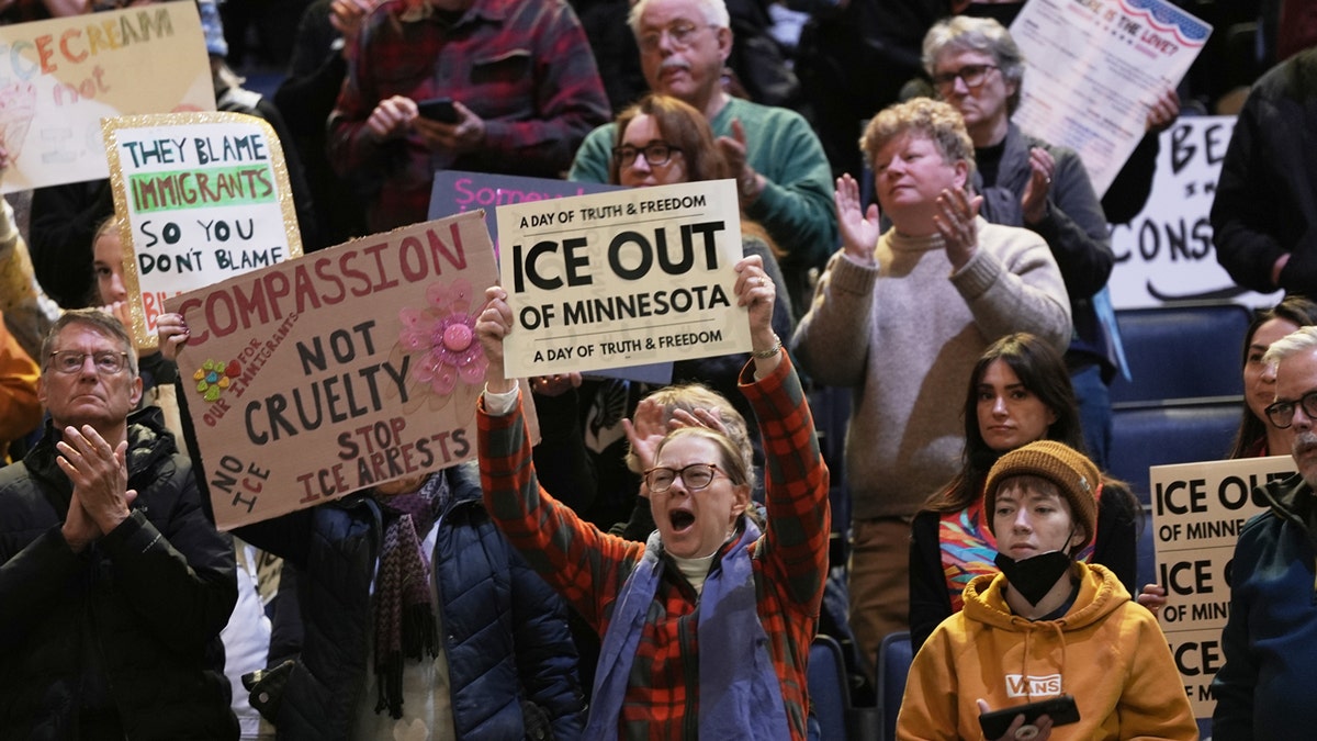 Attendees hold signs during a rally against federal immigration enforcement at Target Center on Friday, Jan. 23, 2026, in Minneapolis.