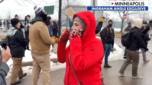 Fox News host Laura Ingraham speaks with a protester during a demonstration.