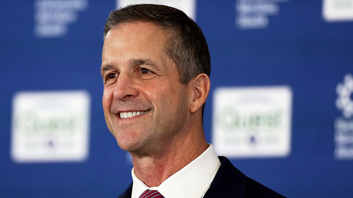 John Harbaugh looks on