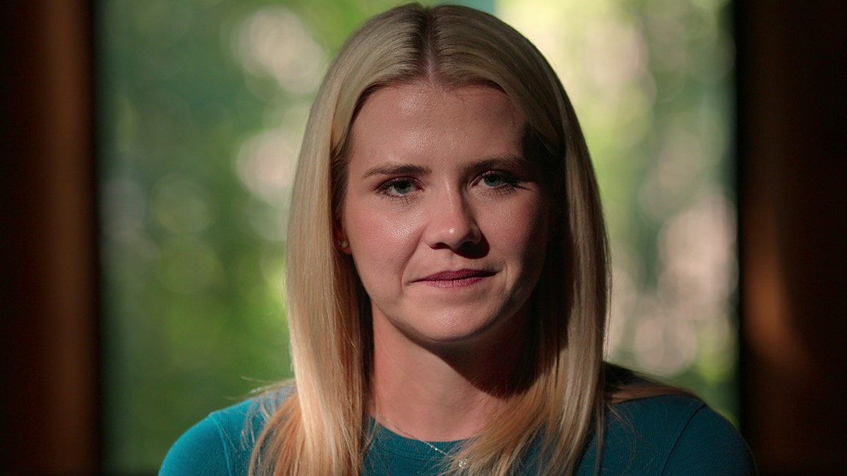 A close-up of Elizabeth Smart wearing a blue sweater.