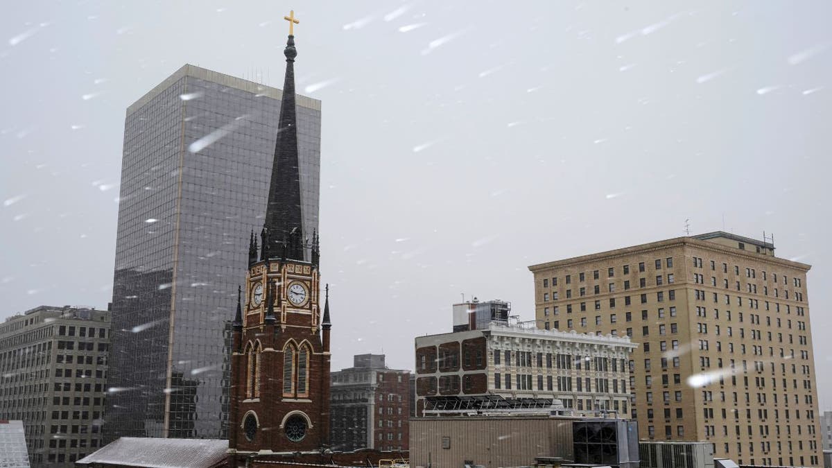 Snow falling over the Louisville skyline during a winter storm