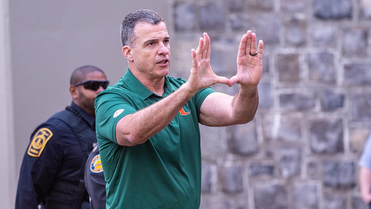 Mario Cristobal makes a "U" with his hands