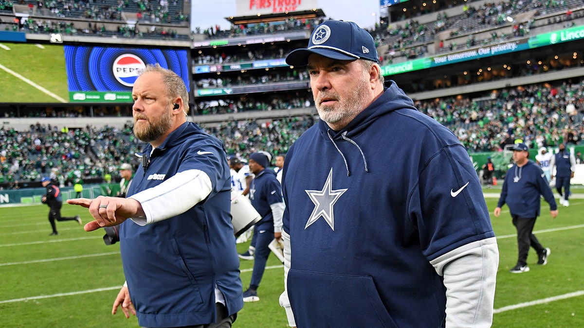 Mike McCarthy walks off field