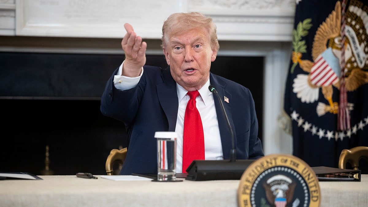 President Donald Trump gestures with his hand