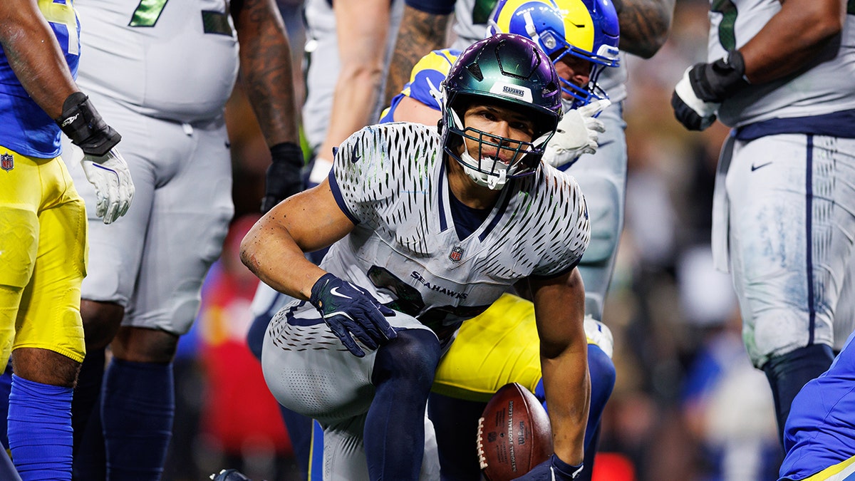 Zach Charbonnet tackled on field