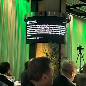 The tweet was displayed on screens around the room as Bell delivered his criticism.