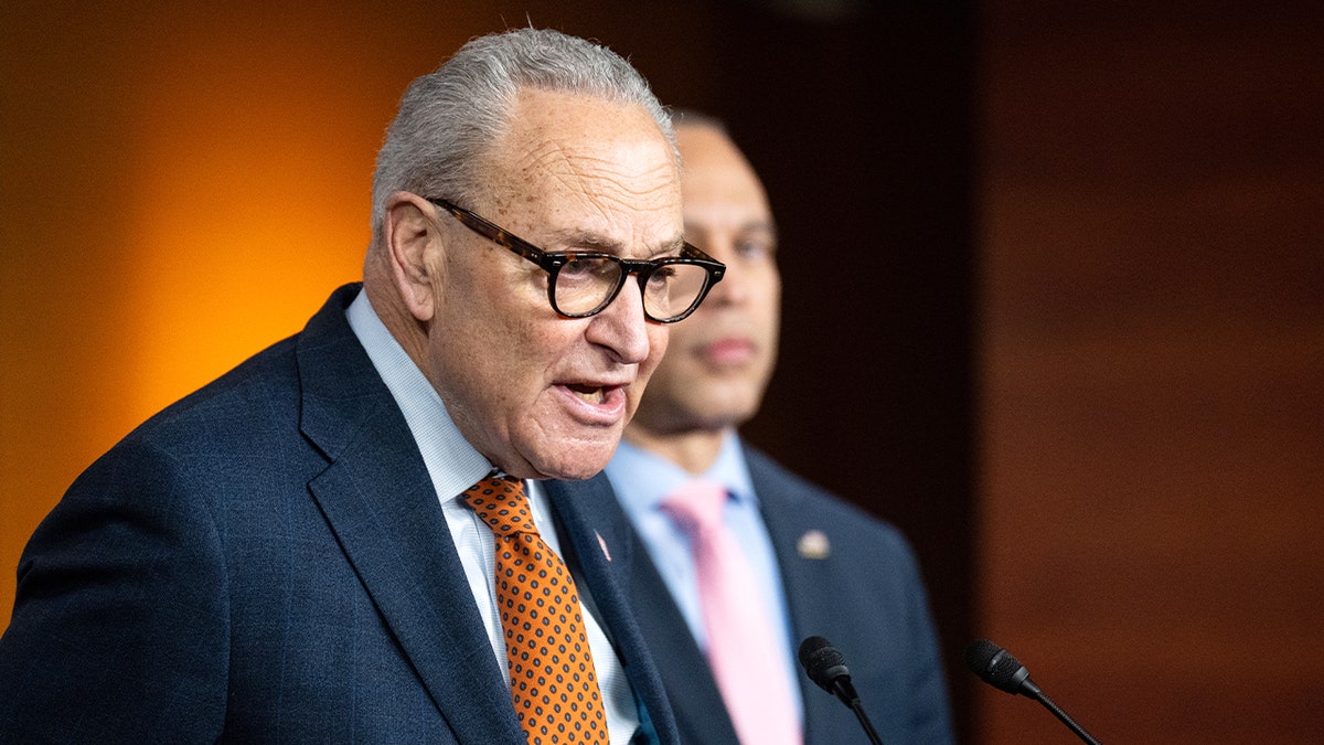 Two Democratic congressional leaders stand side by side at podiums during a news conference inside the U.S. Capitol.