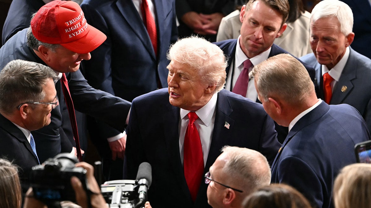 US President Donald Trump shakes hands with members of Congress as he departs following his State of the Union address