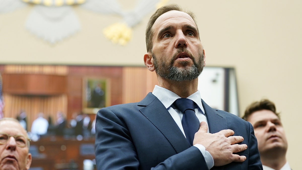 Jack Smith places hand over heart