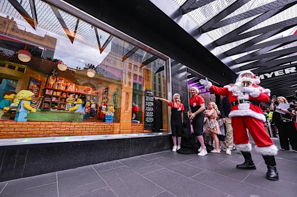 Families enjoying last year’s Myer Christmas windows.