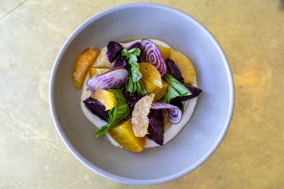 The heirloom beetroot salad with whipped sunflower seed, mustard greens and pieces of orange.