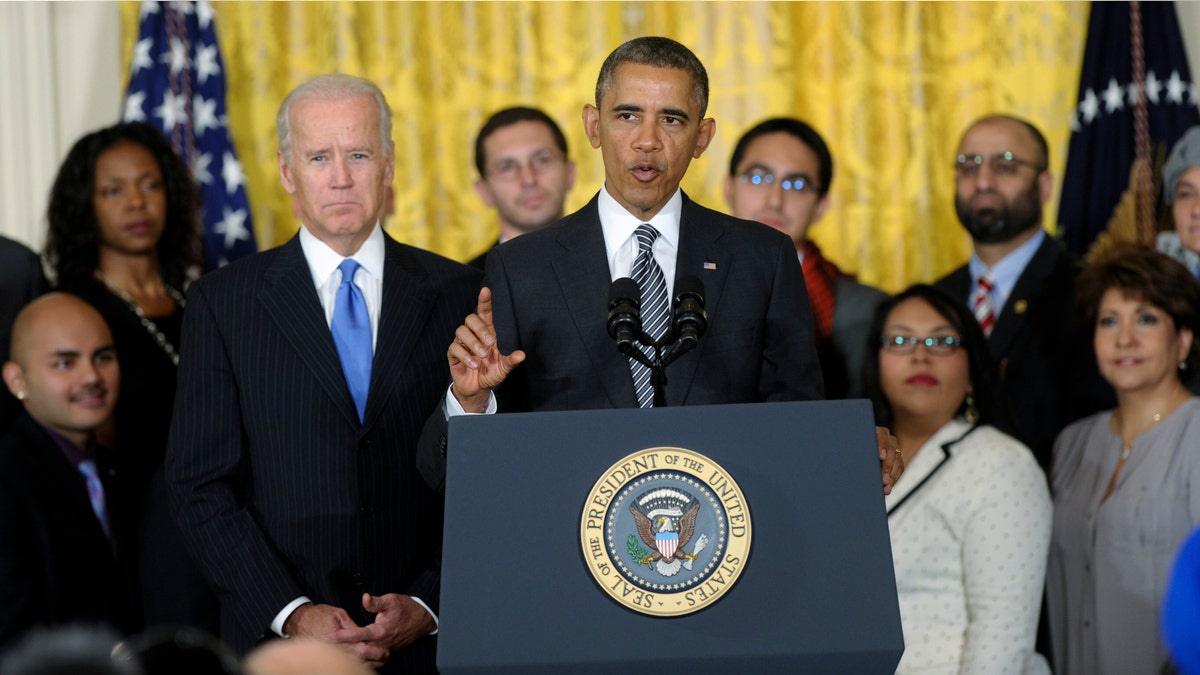 President Barack Obama, standing next to Vice President Joe Biden, urges Congress to take back up comprehensive immigration reform while speaking in the East Room of the White House in Washington, Thursday, Oct. 24, 2013. Obama said now that the partial government shutdown is over, Republicans and Democrats should be able to work together to fix what he called "a broken immigration system." (AP Photo/Susan Walsh)