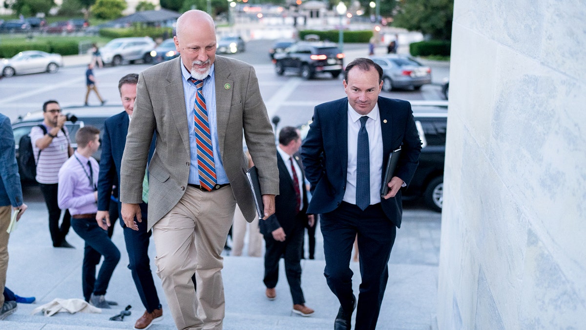 Two Republican lawmakers walk together toward the U.S. Capitol ahead of a congressional vote.