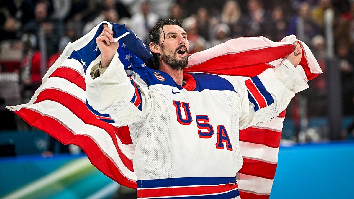 Connor Hellebuyck celebrates gold medal