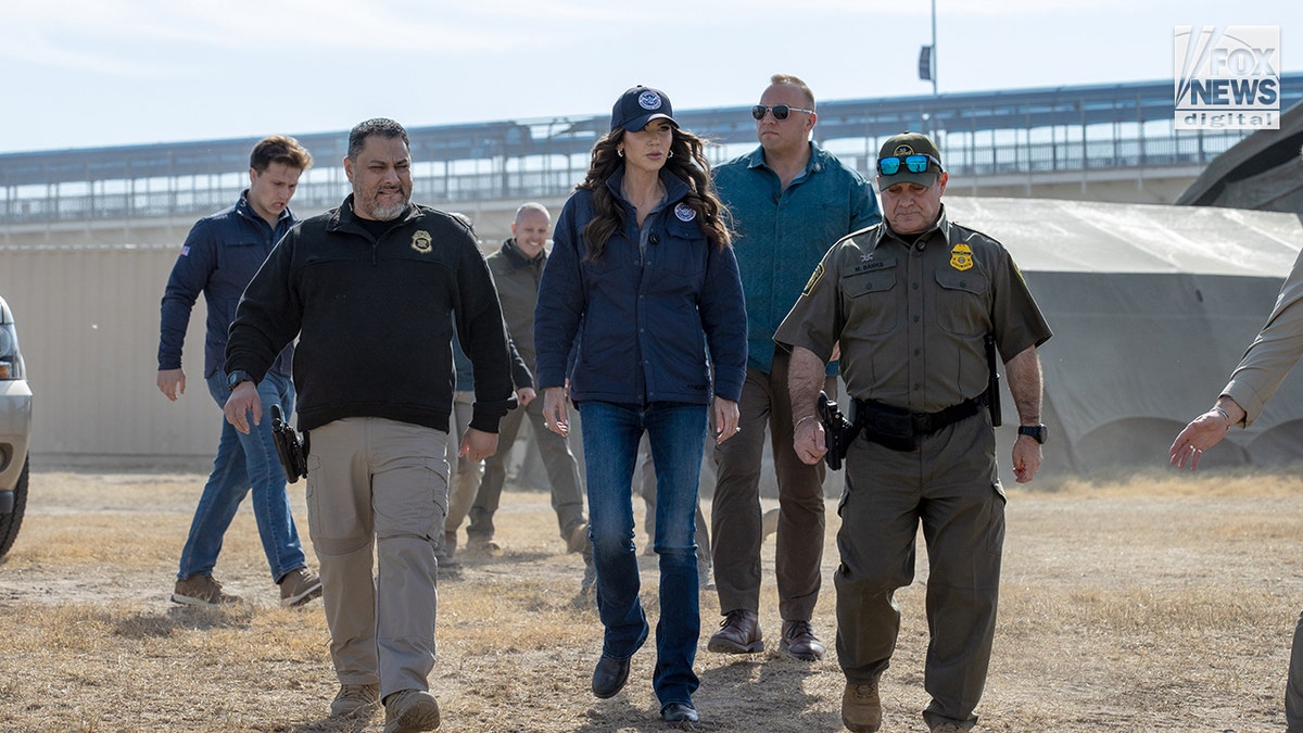 Kristi Noem standing with CBP officials outdoors in Eagle Pass, Texas