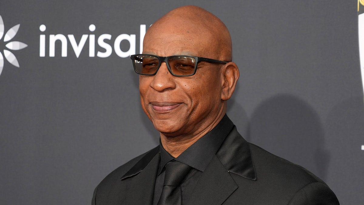 Eric Dickerson looks on