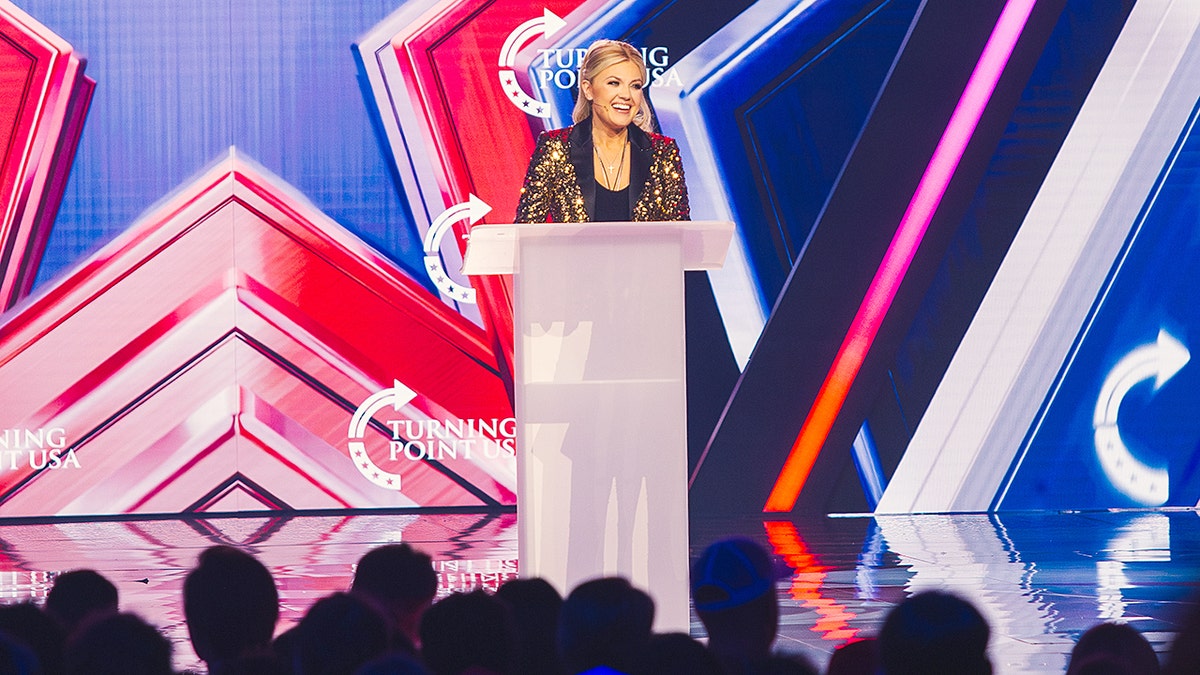 Erika Kirk speaking at a podium during an event in Phoenix.