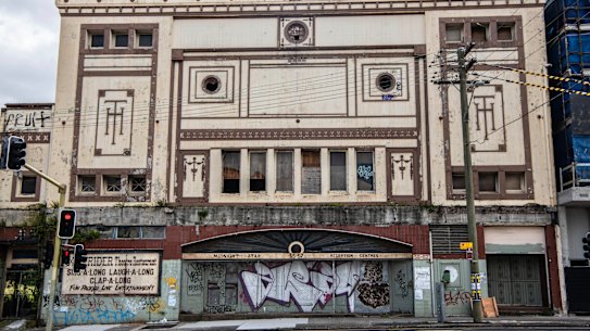 The windows of the former Homebush theatre have been boarded up and its facade vandalised.