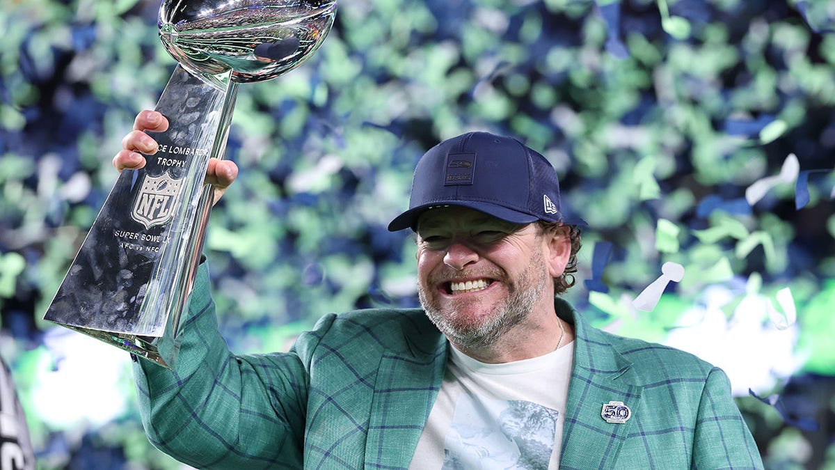 John Schneider holds Super Bowl trophy