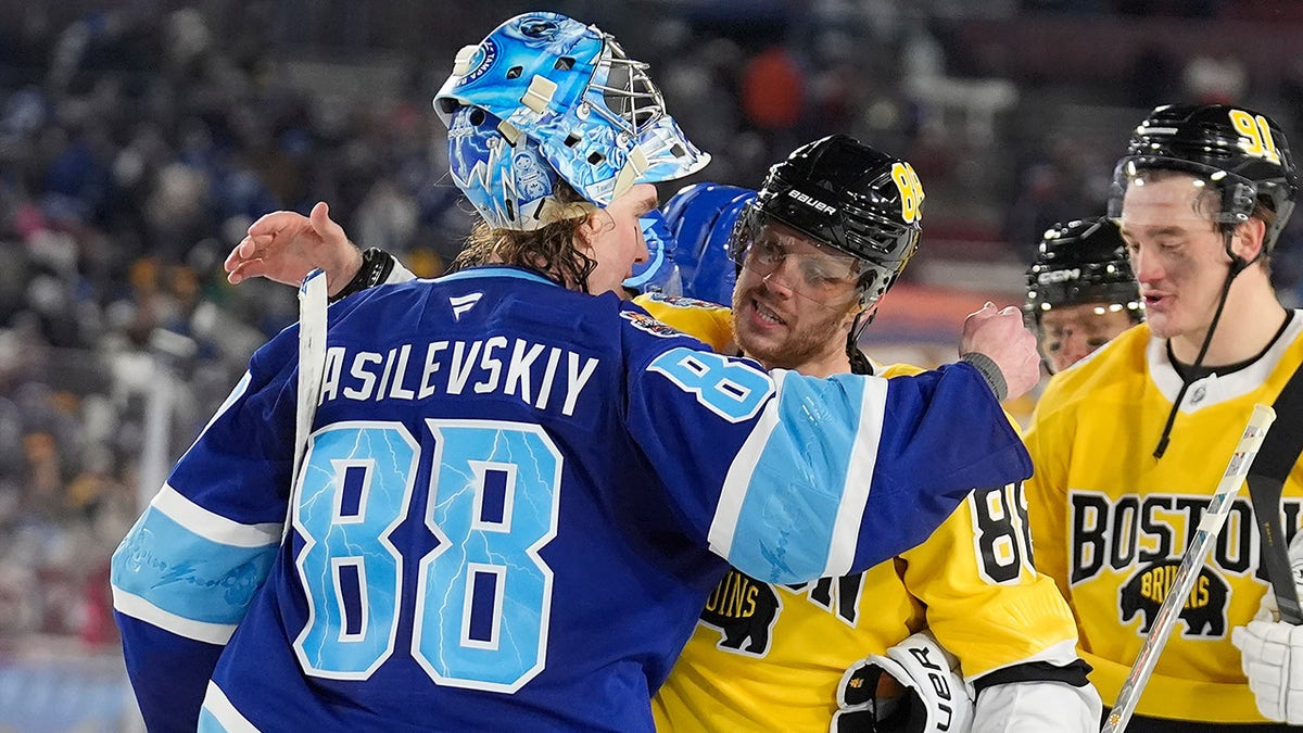 Andrei Vasilevskiy hugs David Pastrnak