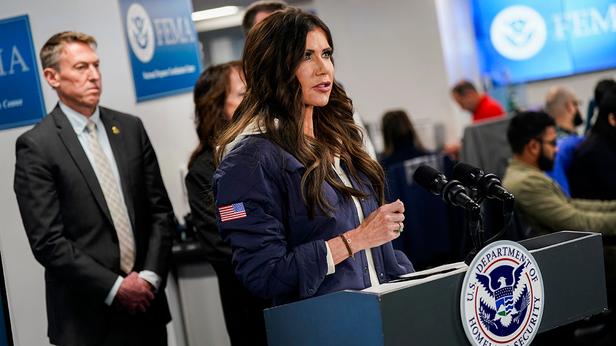 Kristi Noem speaks with DHS staff around her