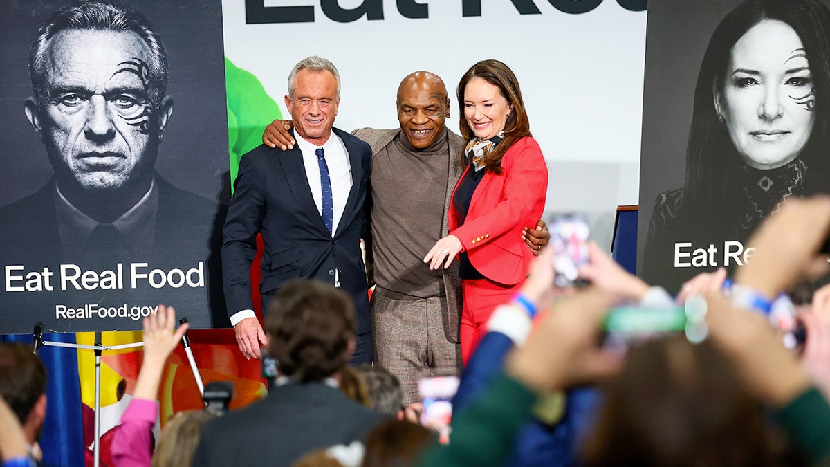 Robert F. Kennedy Jr., Mike Tyson and Brooke Rollins pose at an event
