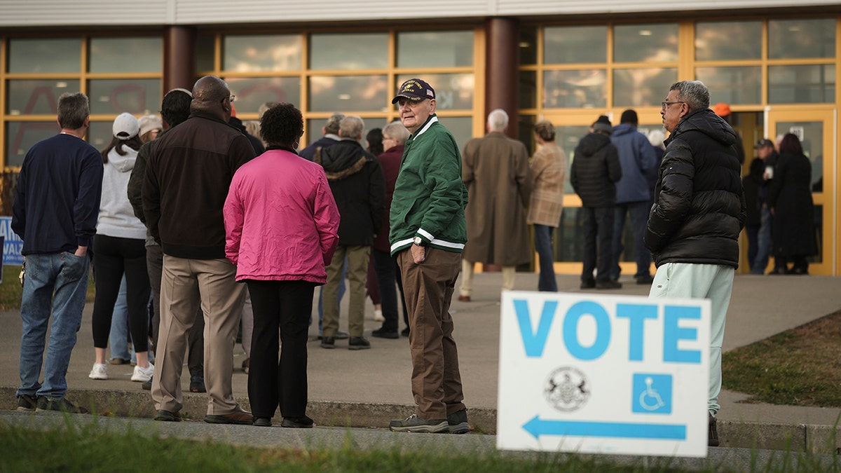 Voters wait in line to cast their ballots at Scranton High School in Scranton, Pa., on Election Day. Scranton is a city in Lackawanna County, where Whatley said poll watchers were initially being denied access.